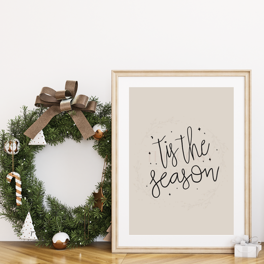 Cream Christmas print with simple handwritten text reading “Tis’ The Season.”