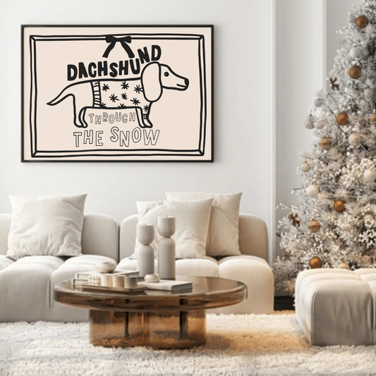Hand-drawn Christmas print of a sausage dog with the text “Dachshund Through the Snow,” available in cream or white.