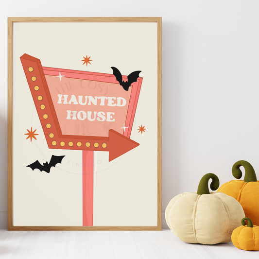 Retro light-up sign pointing to a haunted house in creams and pinks – Halloween wall art by The Cosy Print Company, printed on 200gsm Colour-Lock™ paper, available in A4 and A3 sizes.